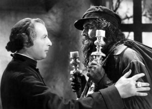 The Bishop (Sir Cedrick Hardwicke) redeeming the life of Jean Valjean (Frederic March) in Les Miserables